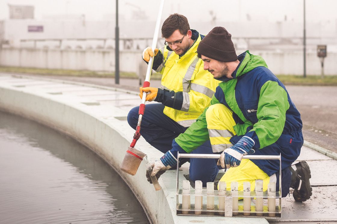 Zwei Umwelttechnologen für Abwasserbewirtschaftung nehmen Wasserproben.